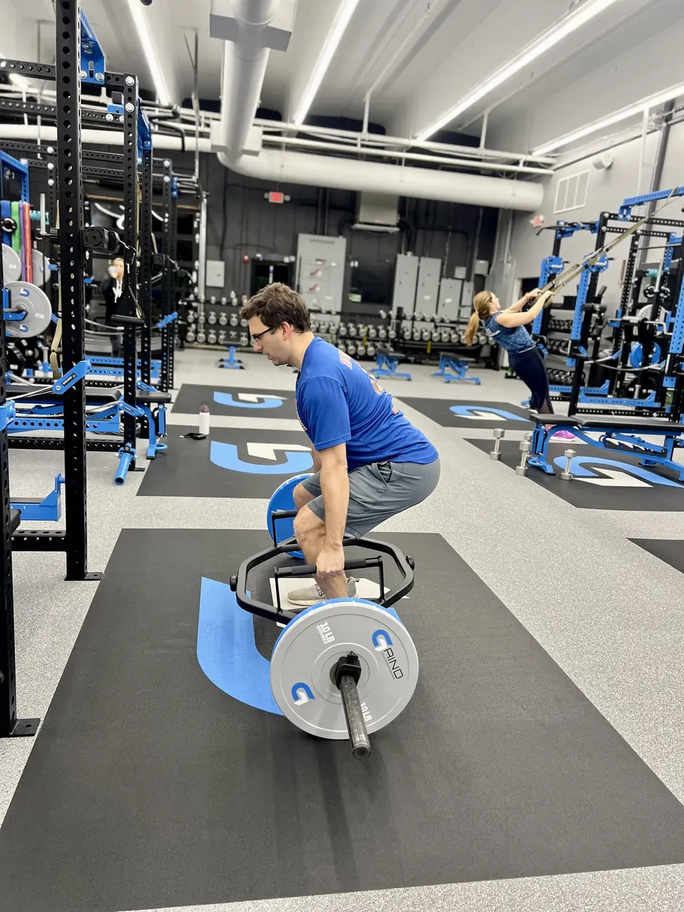 A Vital member completing a coached strength exercise